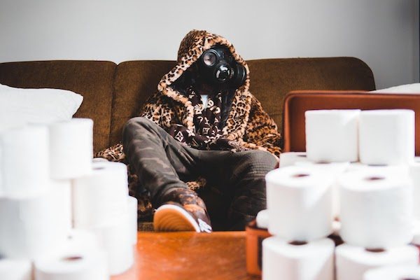 image of man in gas mask with toilet paper prepared for Covid-19: Photo by Erik Mclean on Unsplash